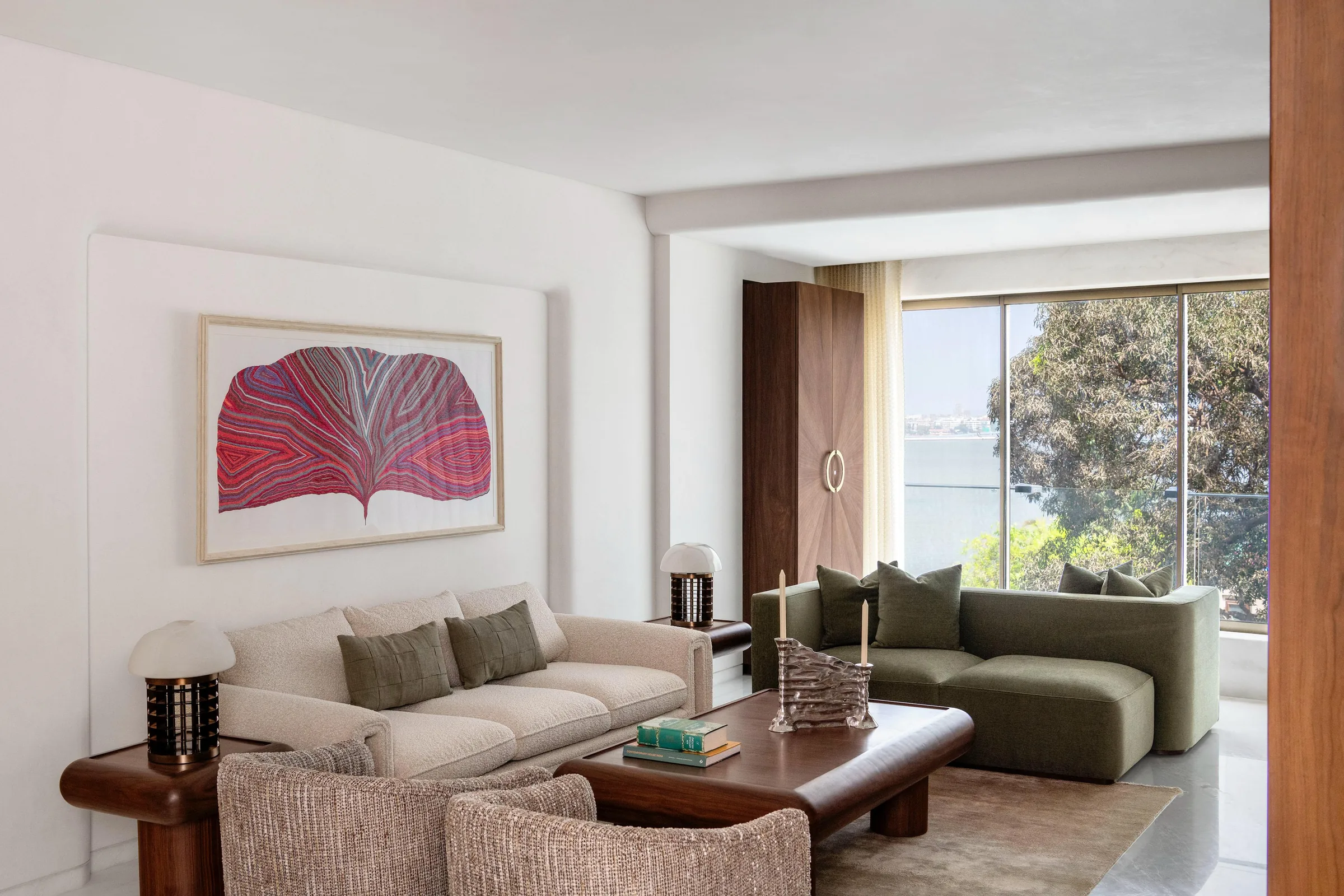 Bombay Design Lab — curved sofas in a light-filled living room